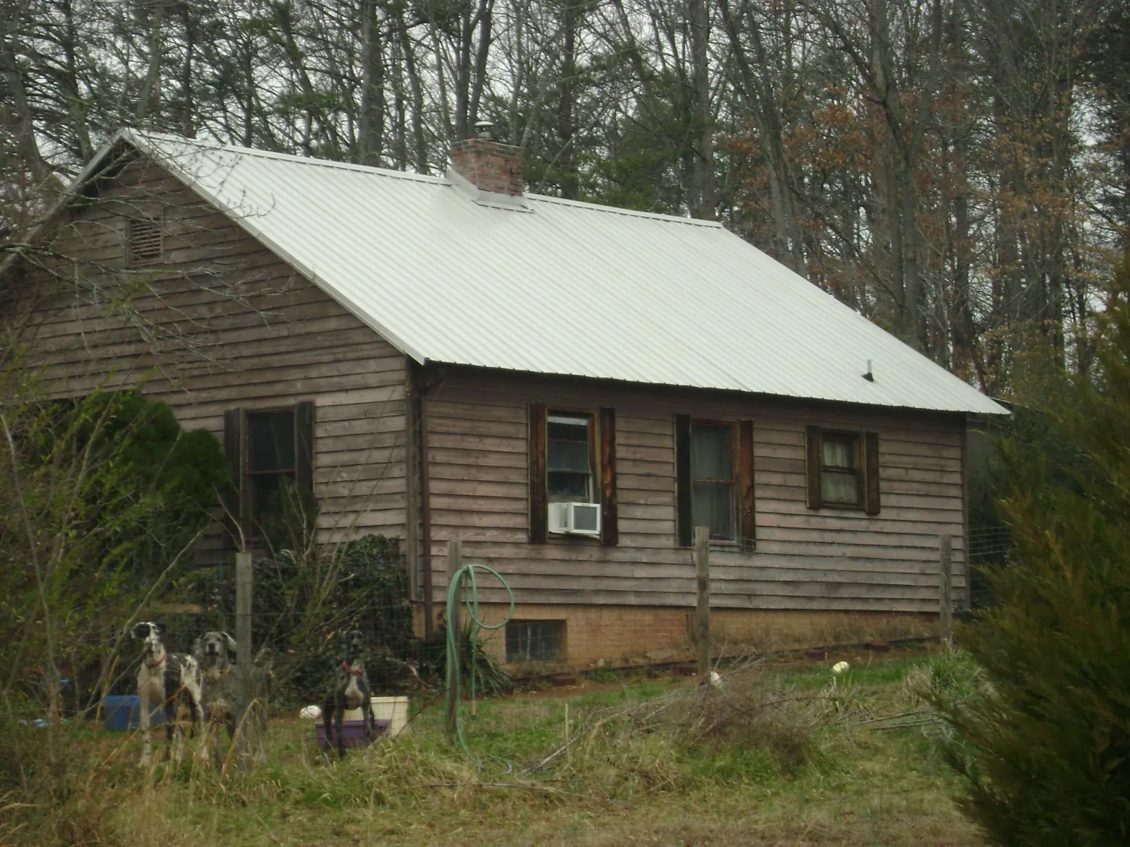 White metal roof on an old wood sided farmhouse, from a Metal Roof Installation job in Arimo